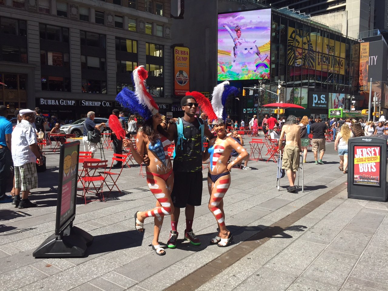 NEW YORK-MAY 20: A Pretty Lady In Patriotic Red, White And Blue Body Paint  Looks For Tips From Tourists With Cameras In Times Square On May 20 2014 In  Manhattan. Stock Photo