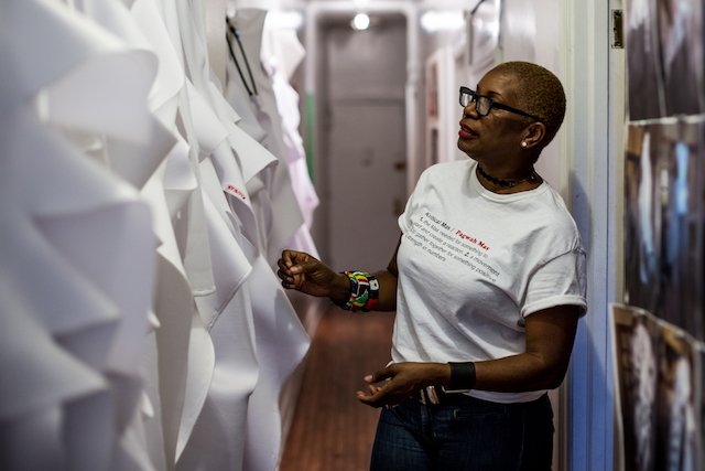 Donna Dove checks her finished patterns of Pagwah mas J'Oouvert costumes in the hallway of her Harlem apartment.