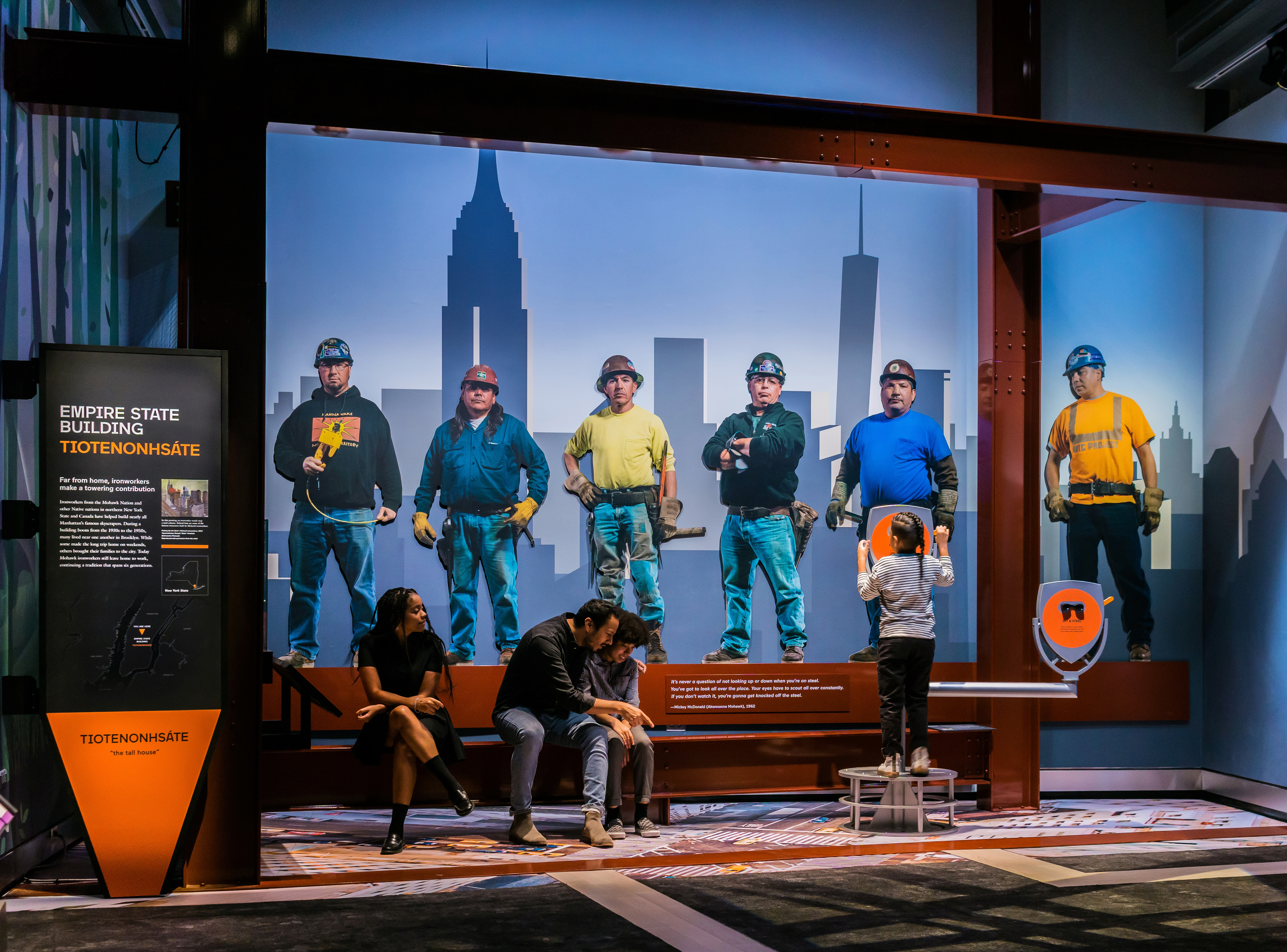 A portrait of several construction workers portraying ironworkers from several indigenous nations who helped build Manhattan's famous skyscrapers.