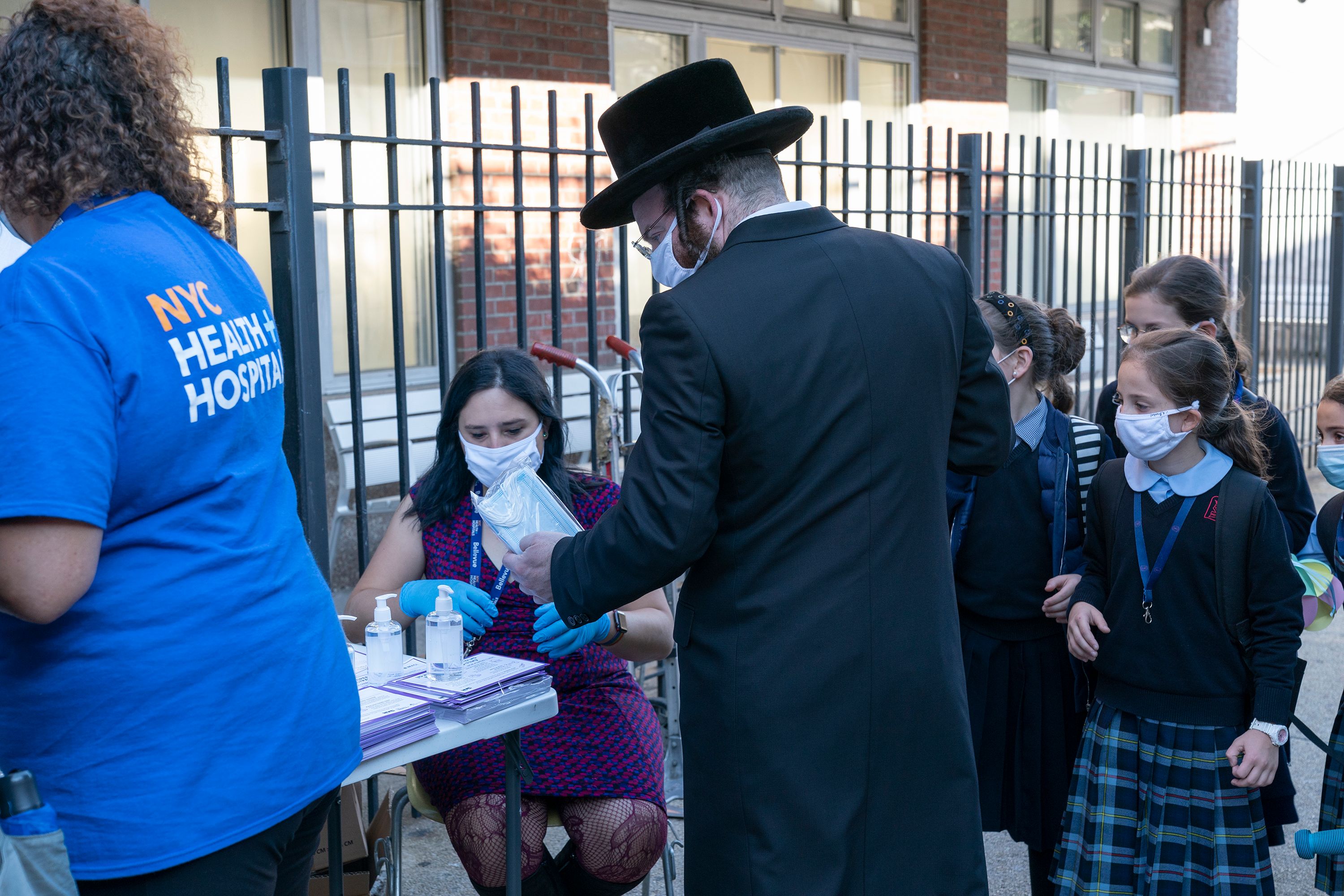 An Orthodox Jewish man in Brooklyn stops by a table manned by the city's Health and Hospitals Corporation informing New Yorkers on the need to get tested.