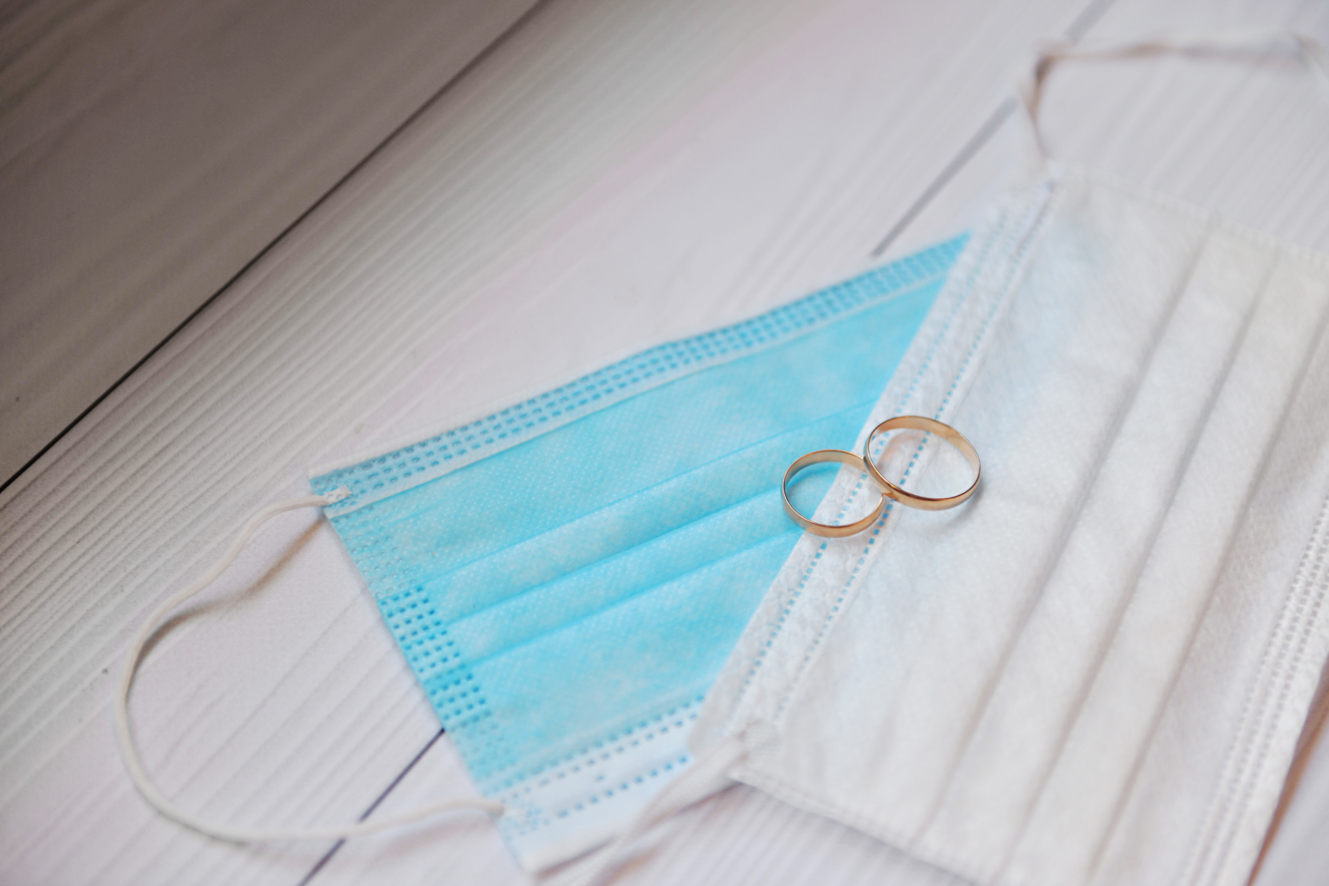 Two surgical masks and two wedding rings