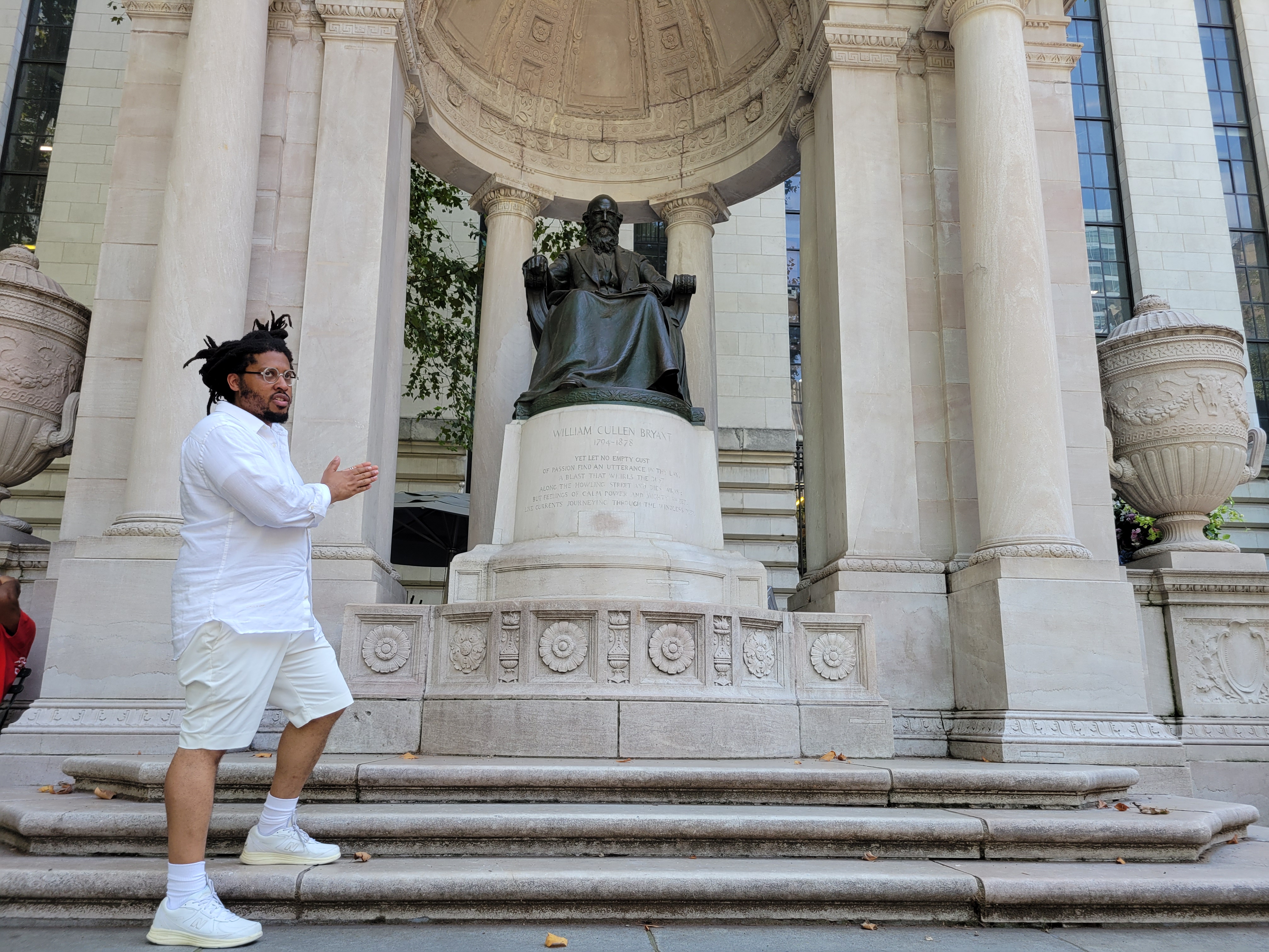 Kamau Ware, founder of the Black Gotham Experience, in front of the William Cullen Bryant statue in Bryant Park.