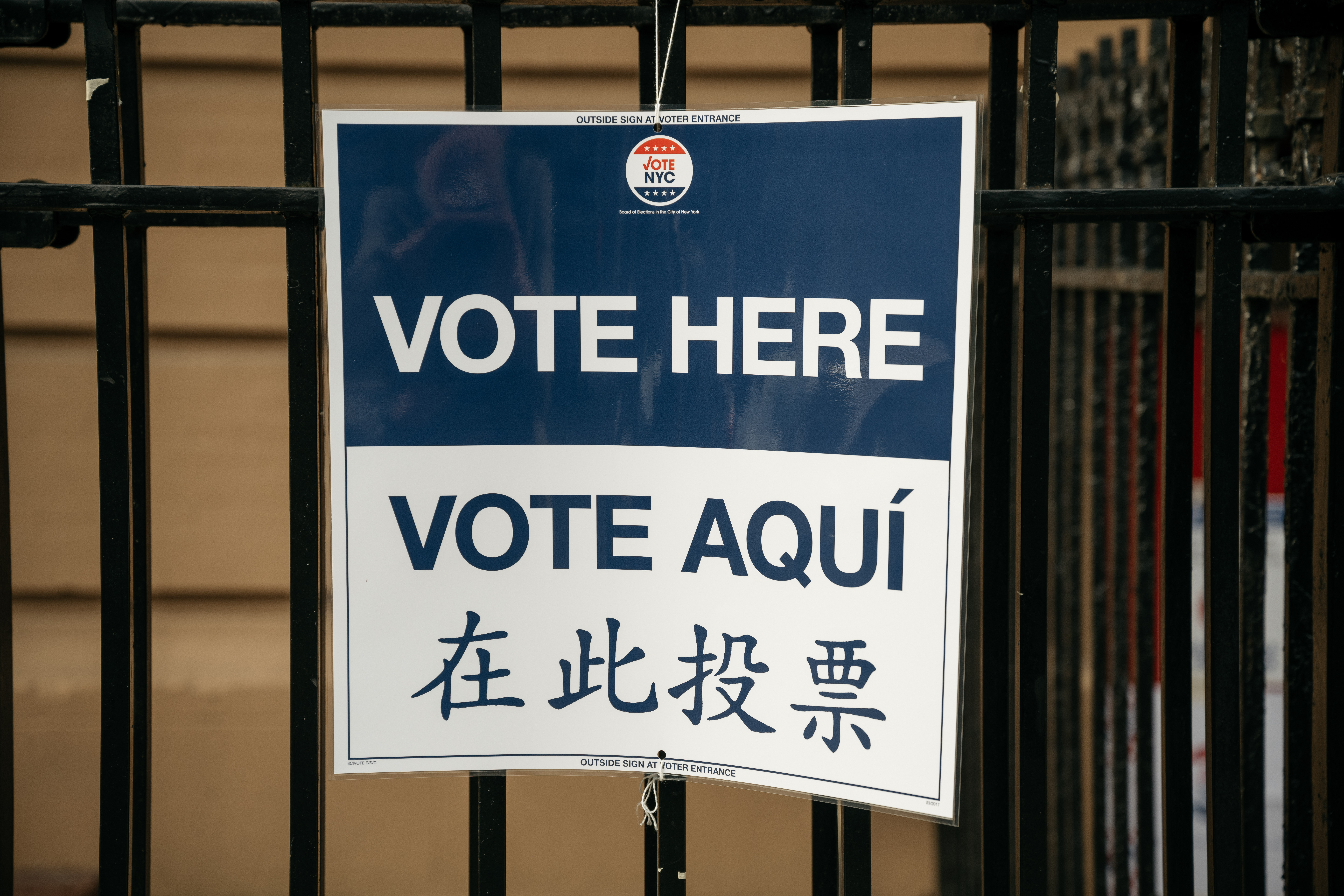 A sign reads "Vote Here".