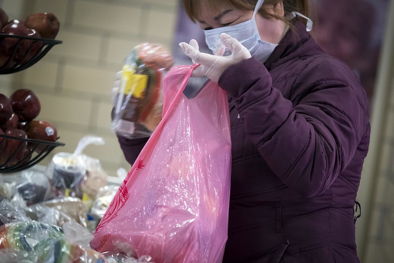 An employee at a school packs a grab-and-go meal on April 7th.