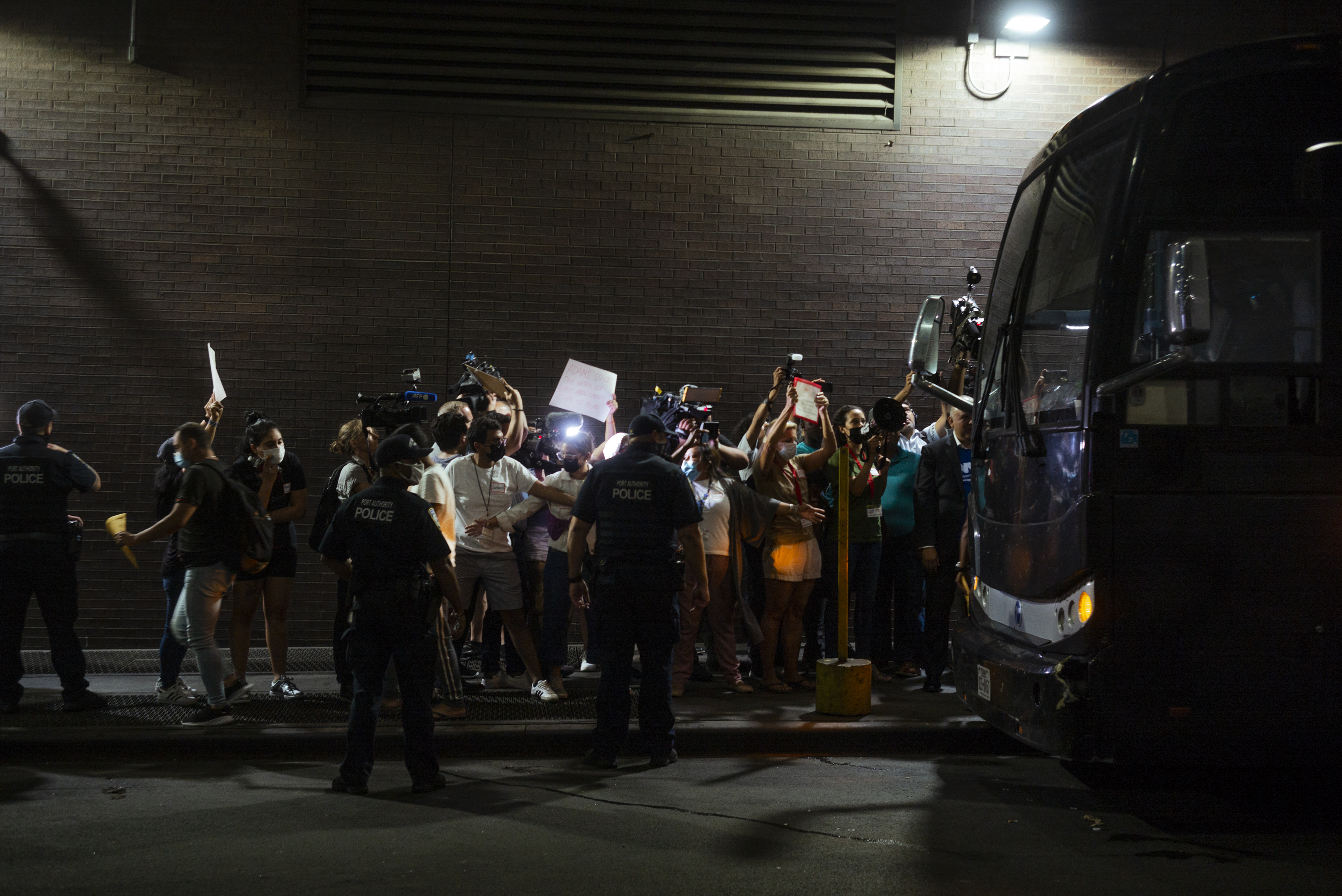 Media and immigrant rights activists gather outside one of the three busses that arrived at Port Authority, from Texas, on Tuesday carrying 80-100 asylum seekers from Central and South America.