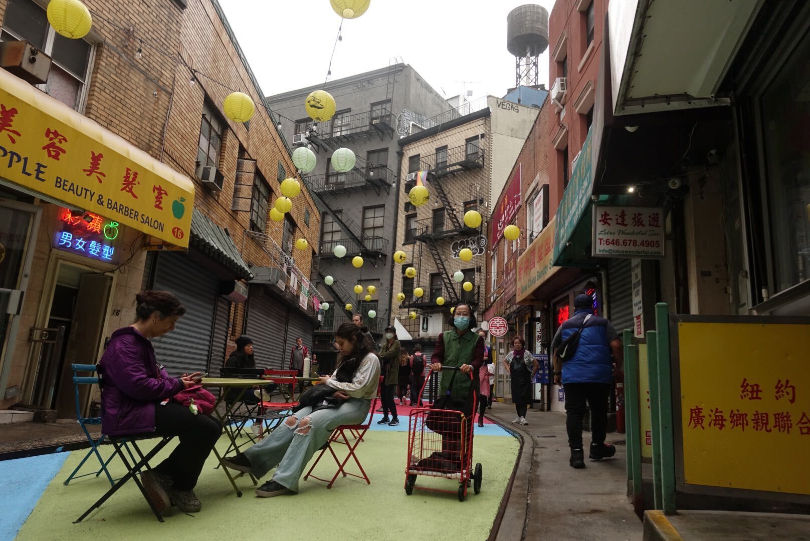 A photo of diners on Doyers Street, one of the city's Open Streets corridors.