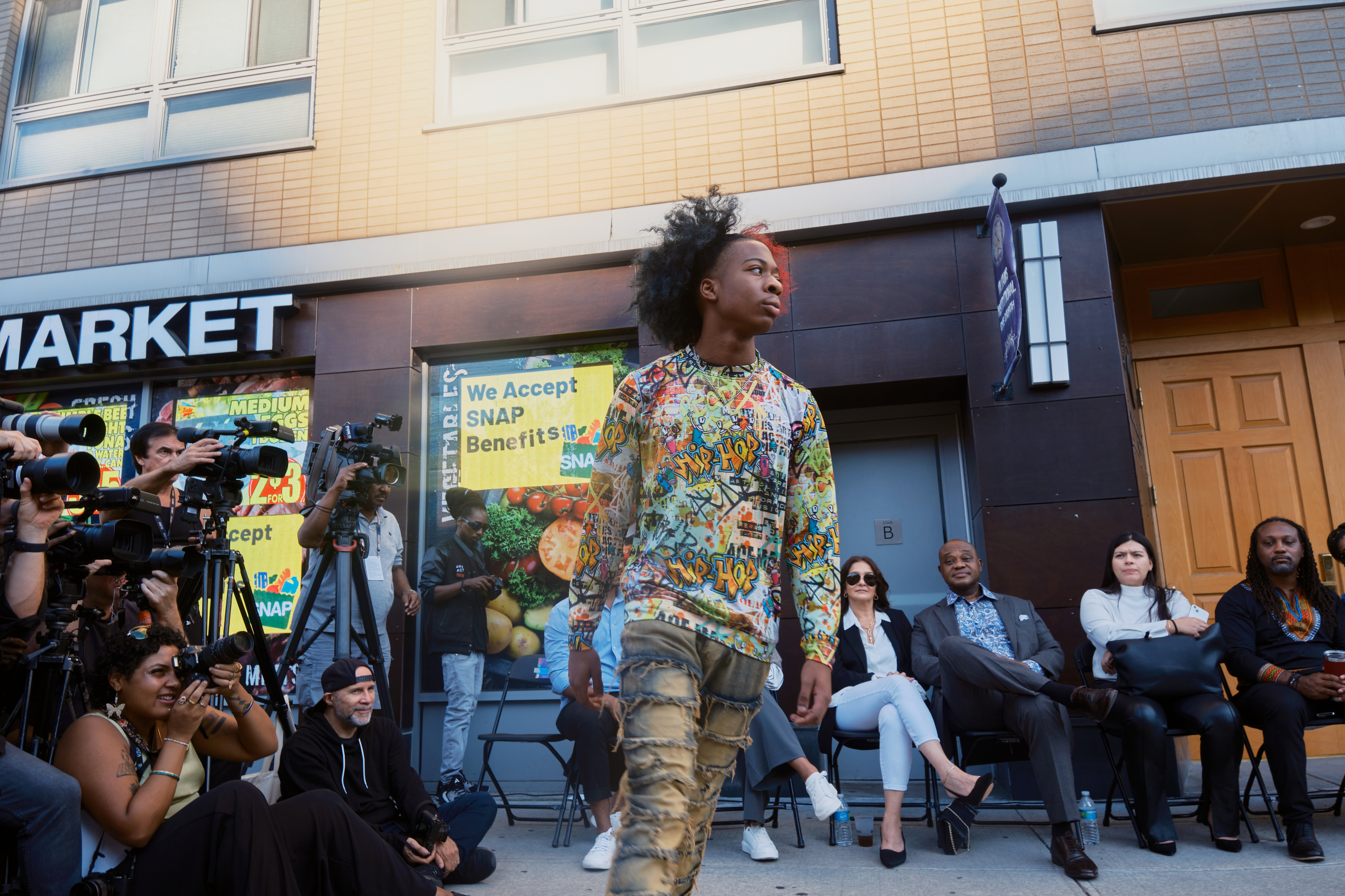 Scenes from a streetside fashion show that put dozens of models down the runway who were either formerly incarcerated or have family members behind bars.