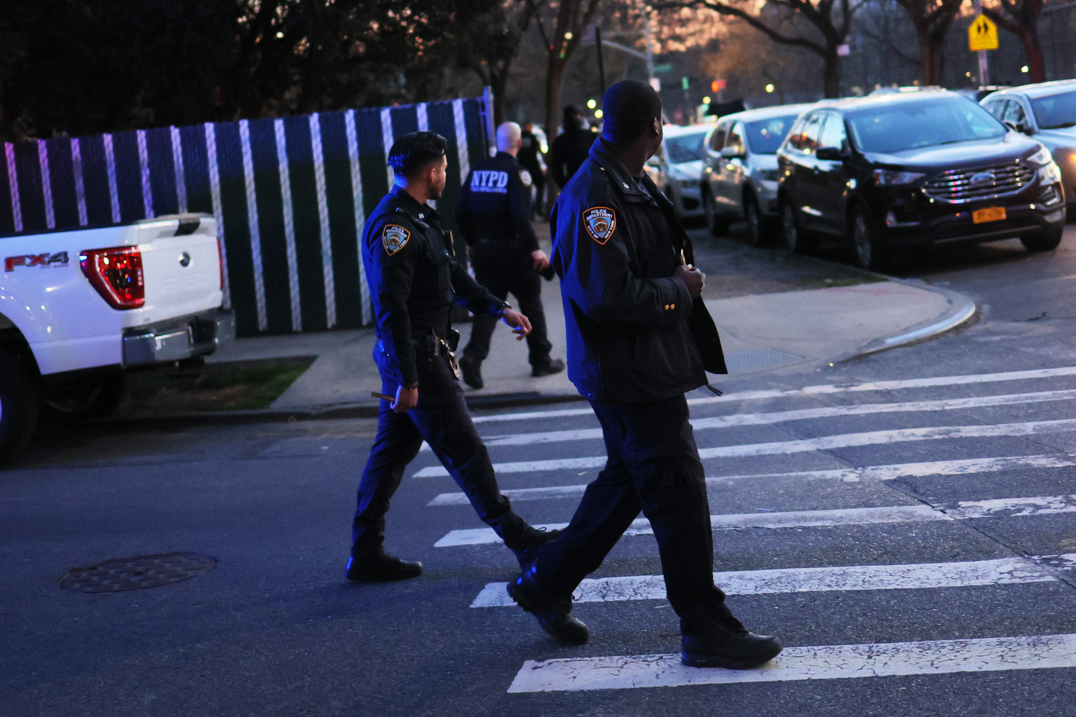 New York City police officers walk to their patrol cars.