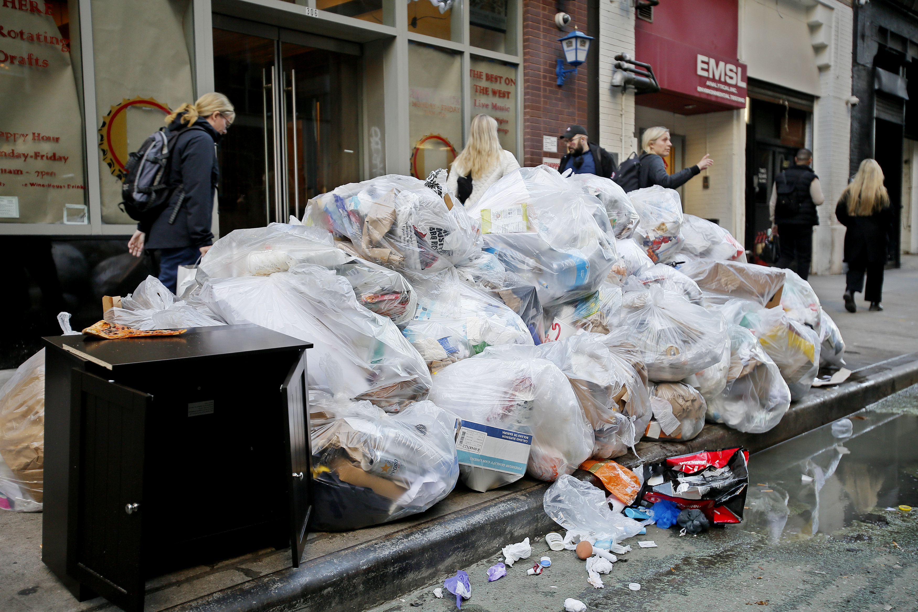 Black Trash Bags Along A Street And Sidewalk In Greenwich Village