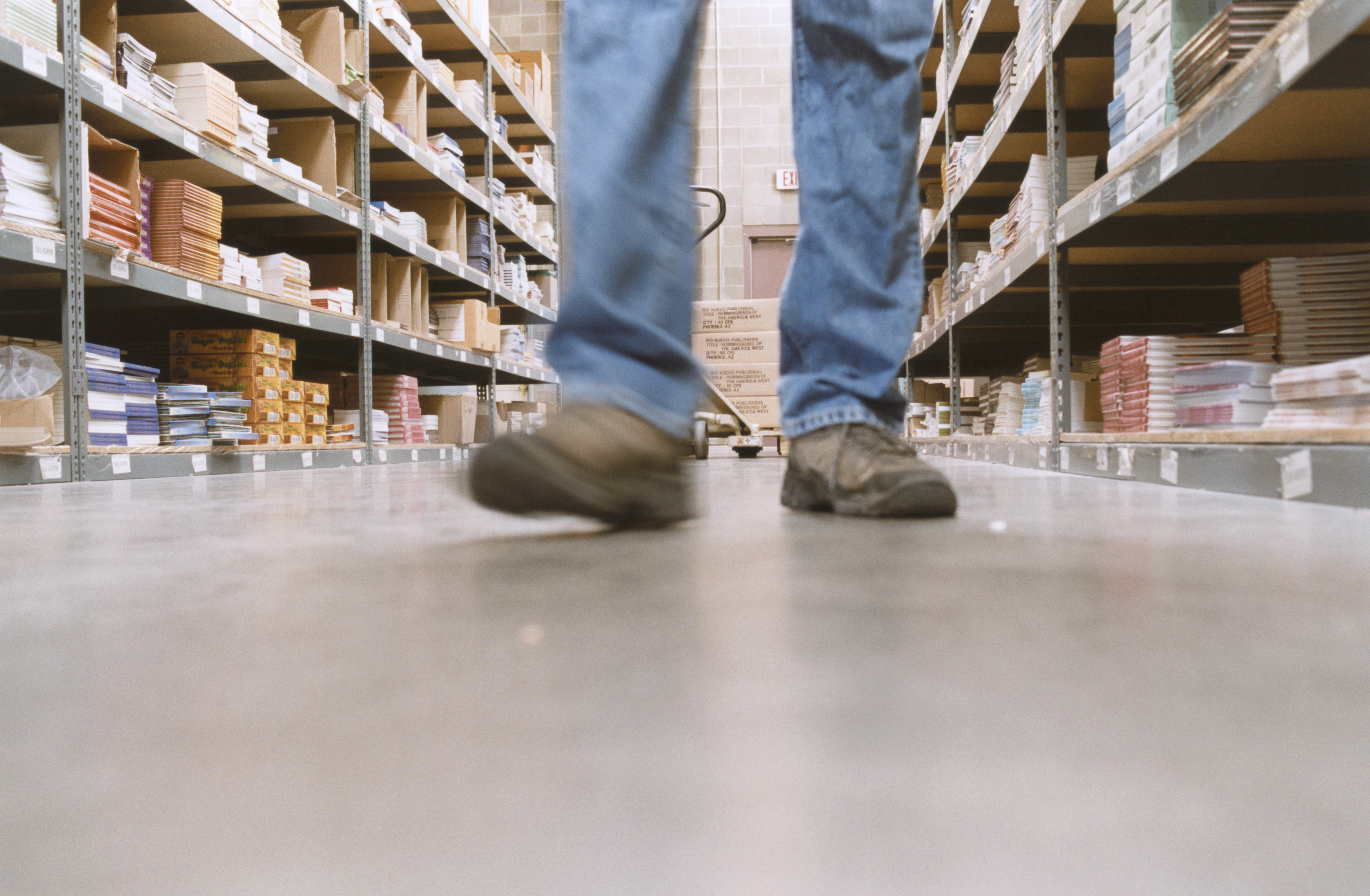 A warehouse worker walks through an aisle. Temporary workers account for about one quarter of New Jersey's growing warehouse industry.