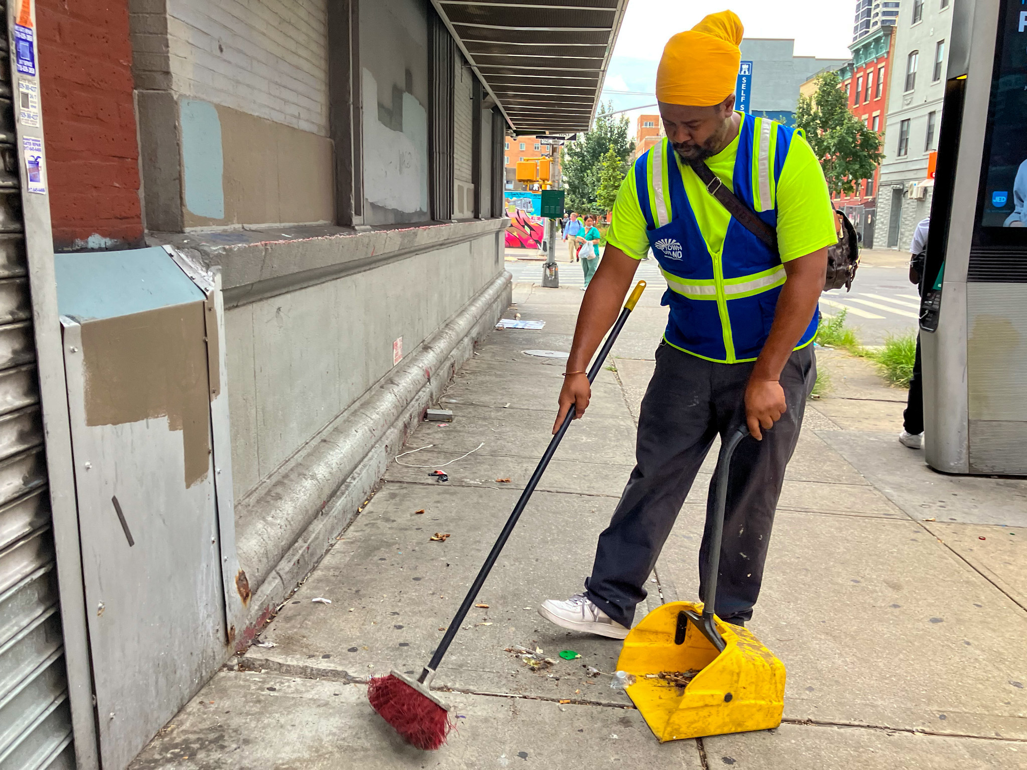 Jason McDavid cleans the city streets near the Metro North station on 125th Street in East Harlem.
