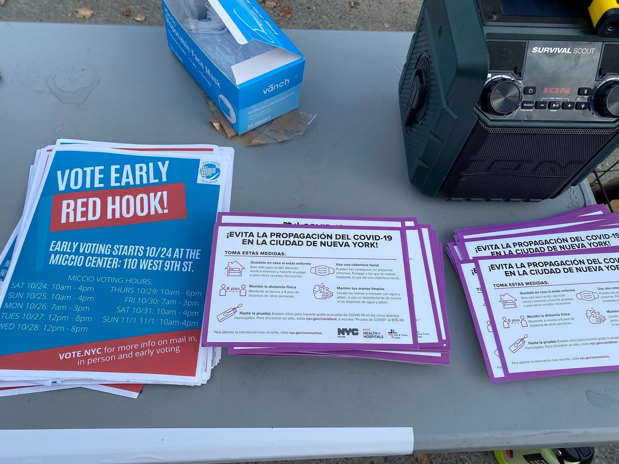 Picture of the offending table with the fliers about early voting and COVID-19.
