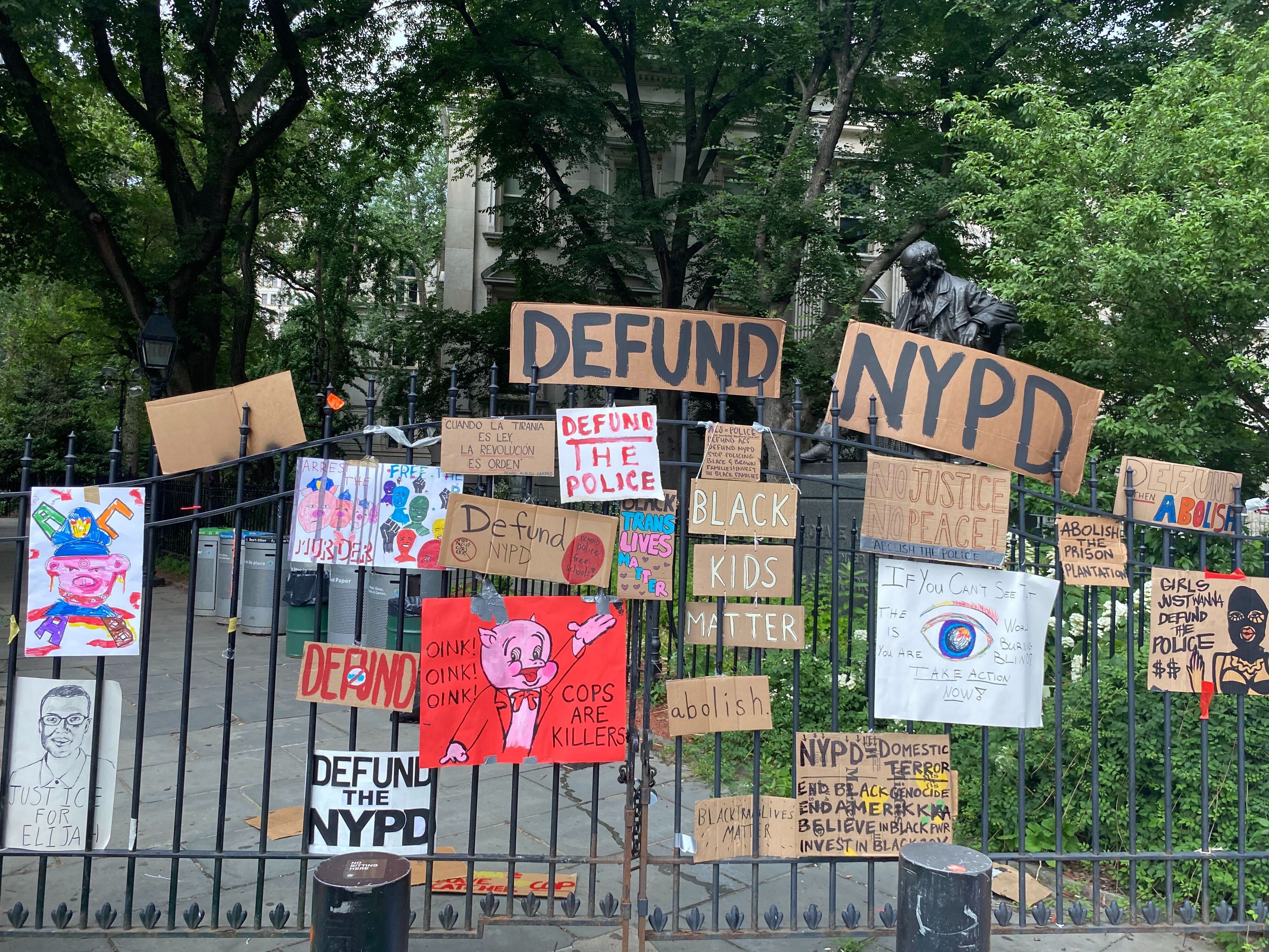 A collection of signs at the Occupy City Hall protests