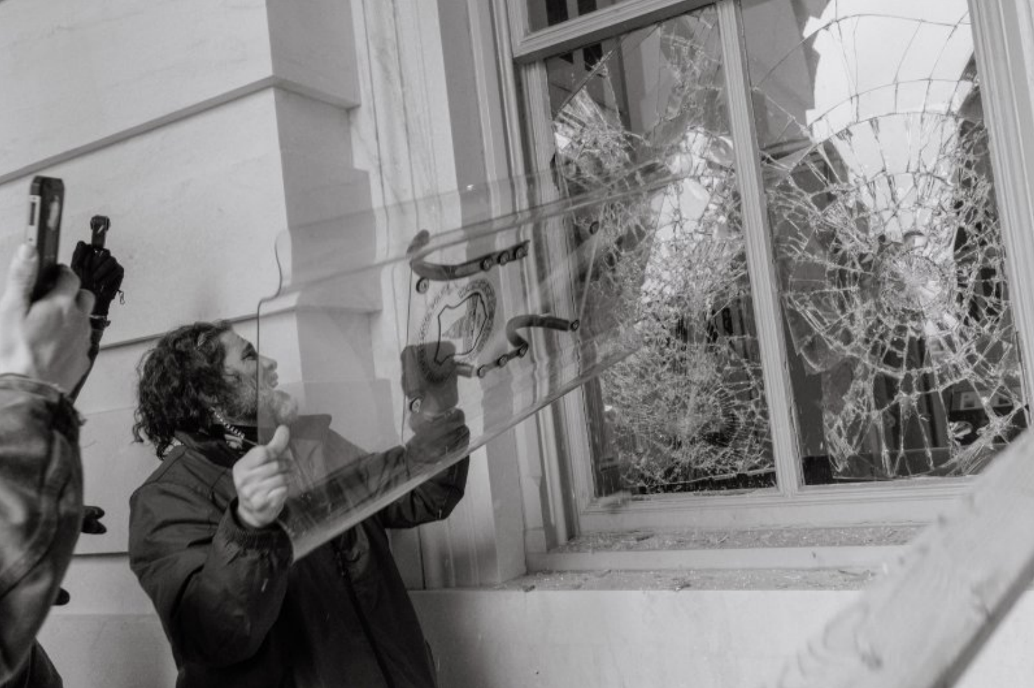 A photo of Dominic Pezzola allegedly using a riot shield to smash windows during the breach of the U.S. Capitol, as released in court documents.