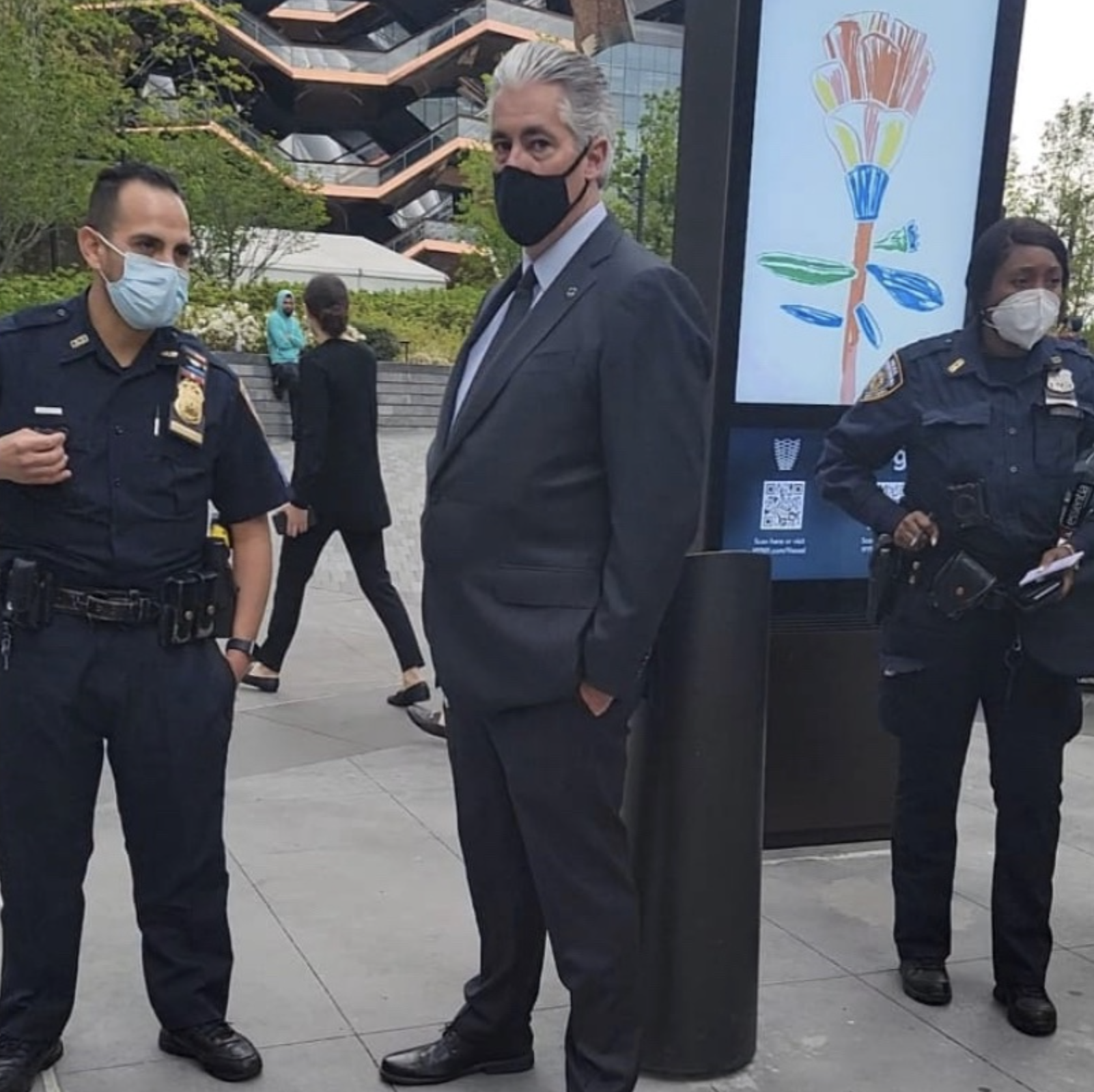 Two NYPD officers flanking a Hudson Yards security guard earlier this week. Vendors allege the developer instructed the cops to issue the tickets