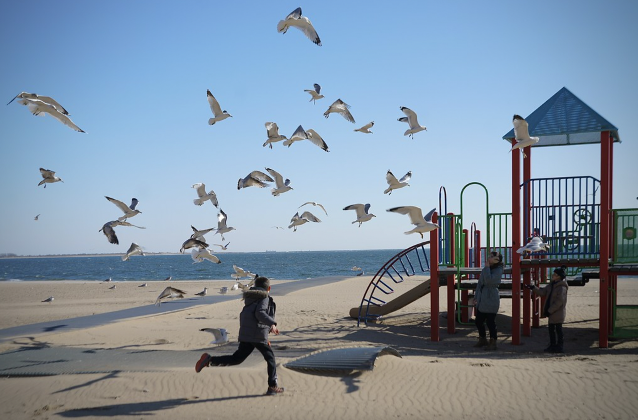 kids play on a near-empty Brighton Beach