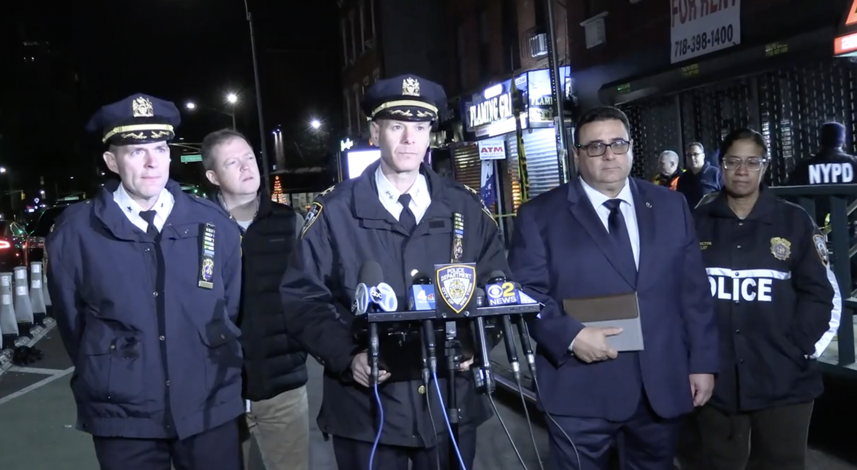 A photo of police and transit officials briefing reporters on a Tuesday night shooting