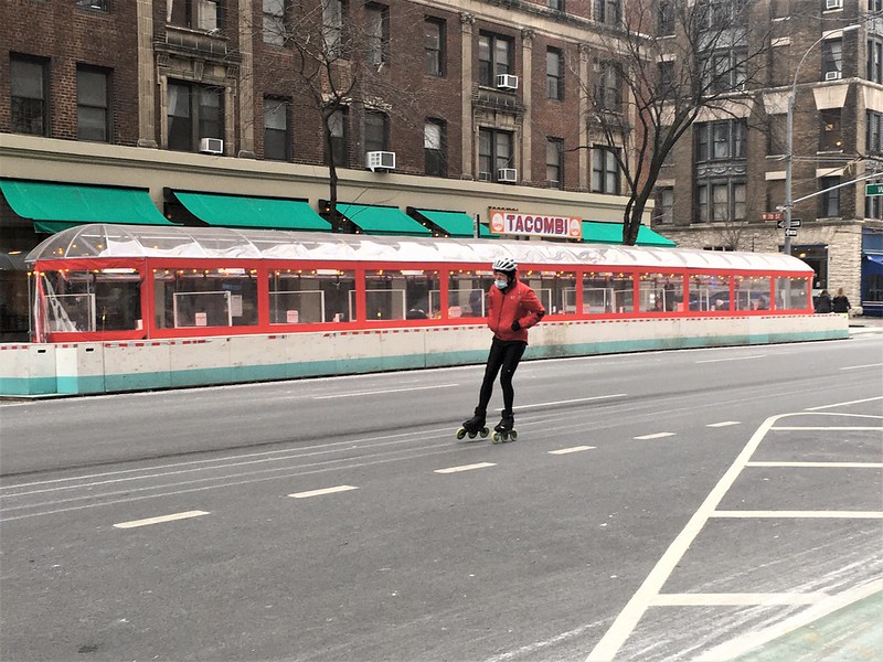 someone rollerblades up an empty Amsterdam Ave