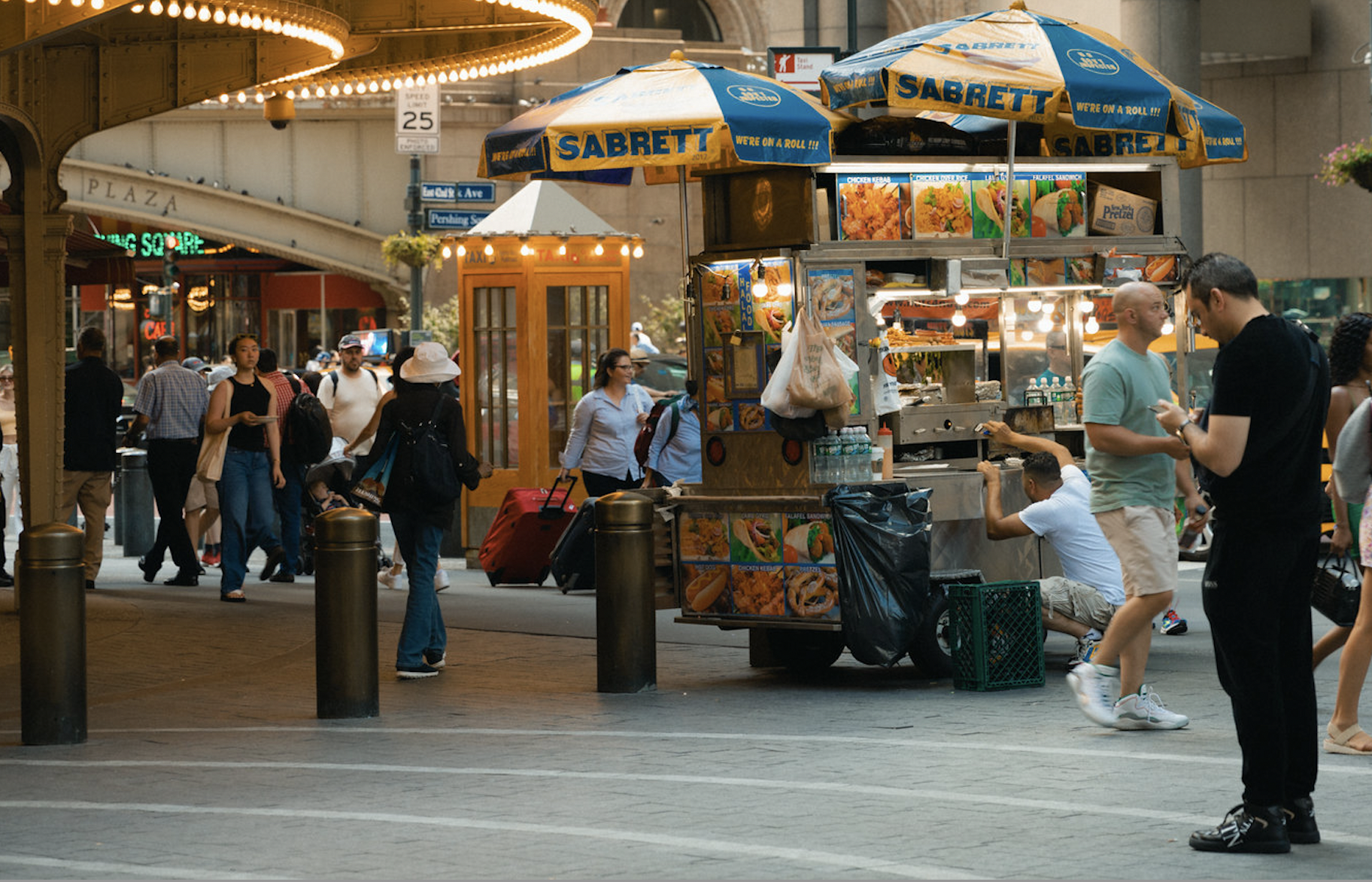 a guy checks his cell phone in Pershing Square outside Grand Central