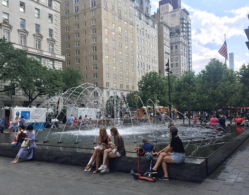 people sitting around the fountain outside the Met