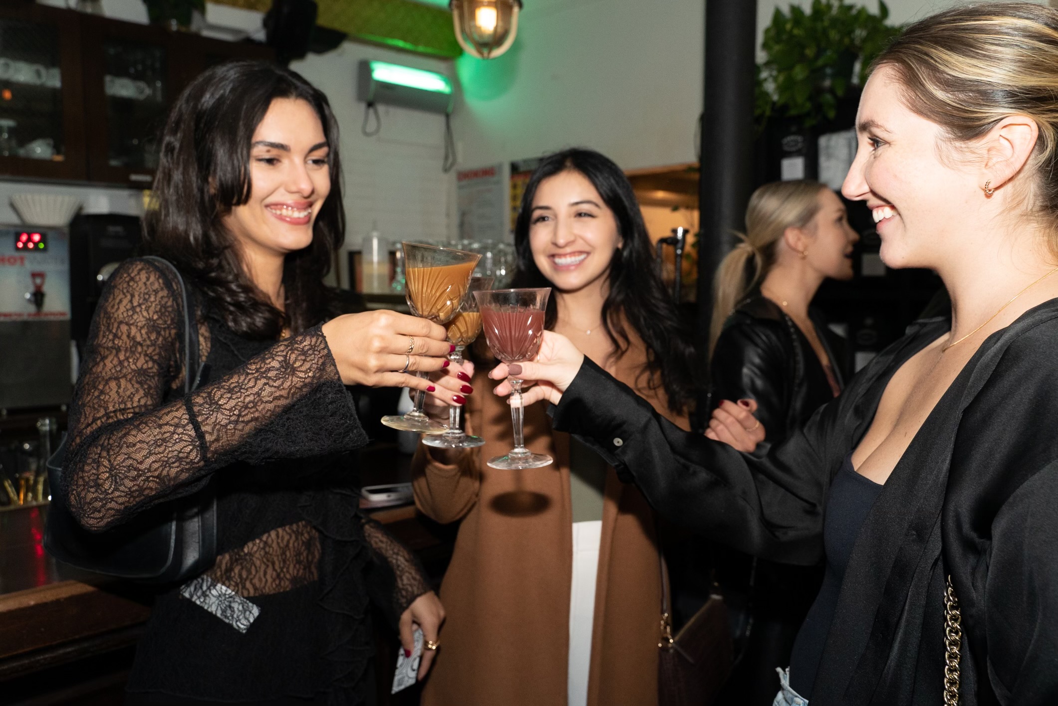 Bar patrons cheers their glasses at the Absence of Proof sober pop-up in Manhattan.