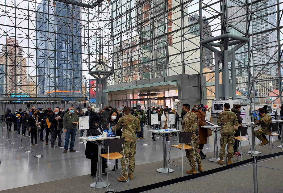 People wait on lines to get vaccinated as National Guard soldiers stand by at the Jacob Javits Center in Manhattan on Saturday, March 6th.