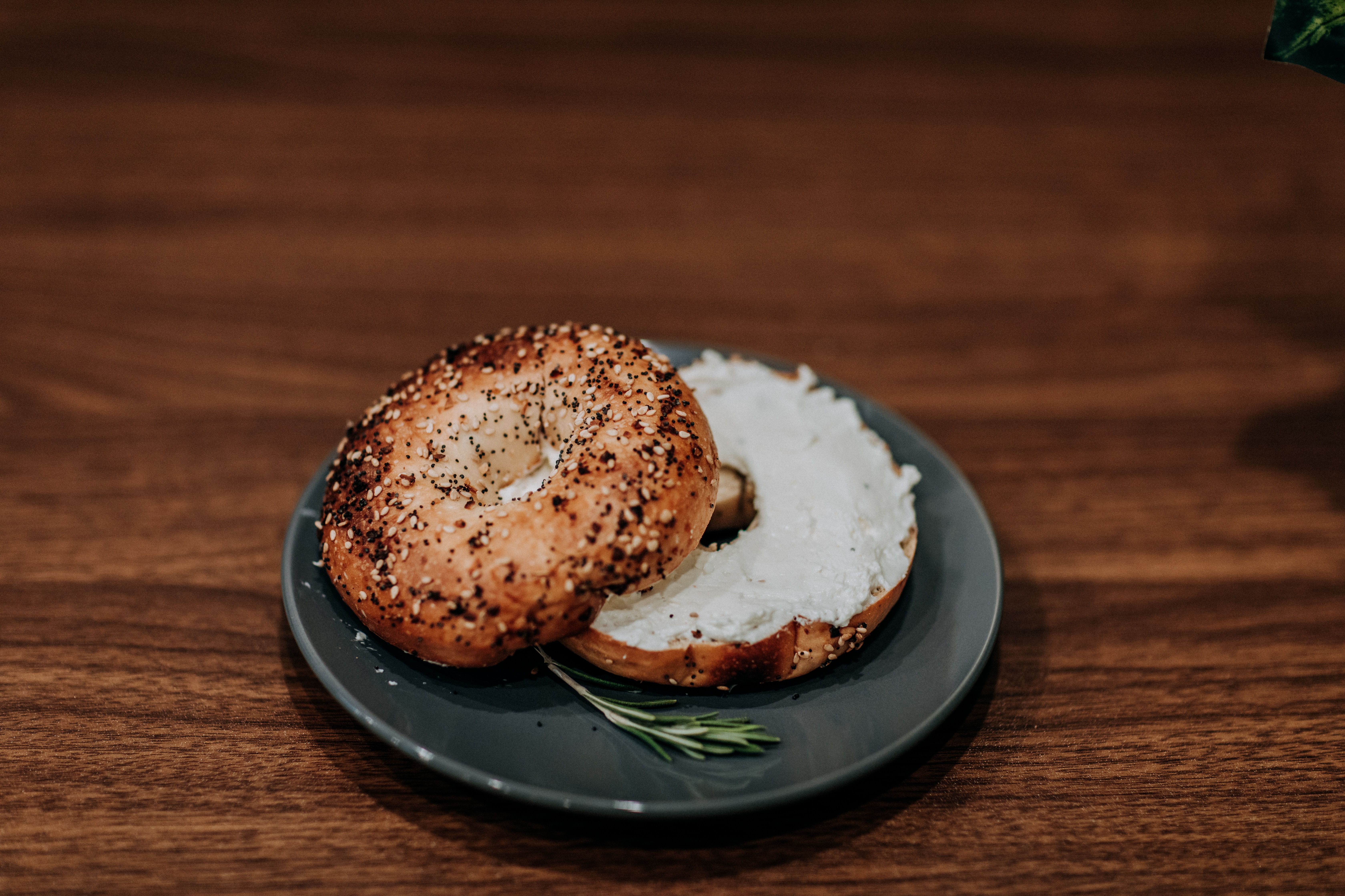 An open-faced bagel with cream cheese.