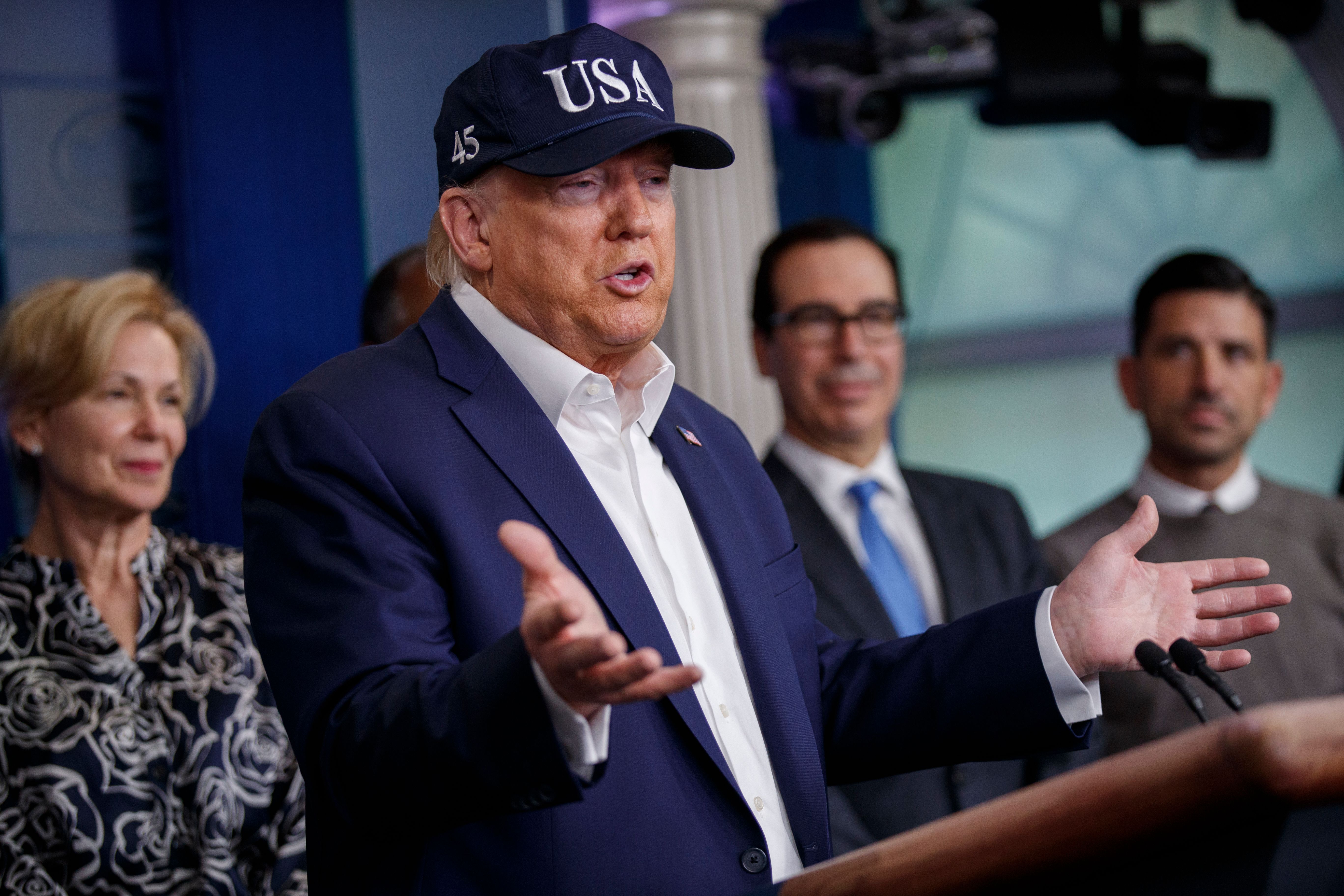 US President Donald Trump, with members of the COVID-19 coronavirus task force, responds to a question from the news media during a press conference in the press briefing room