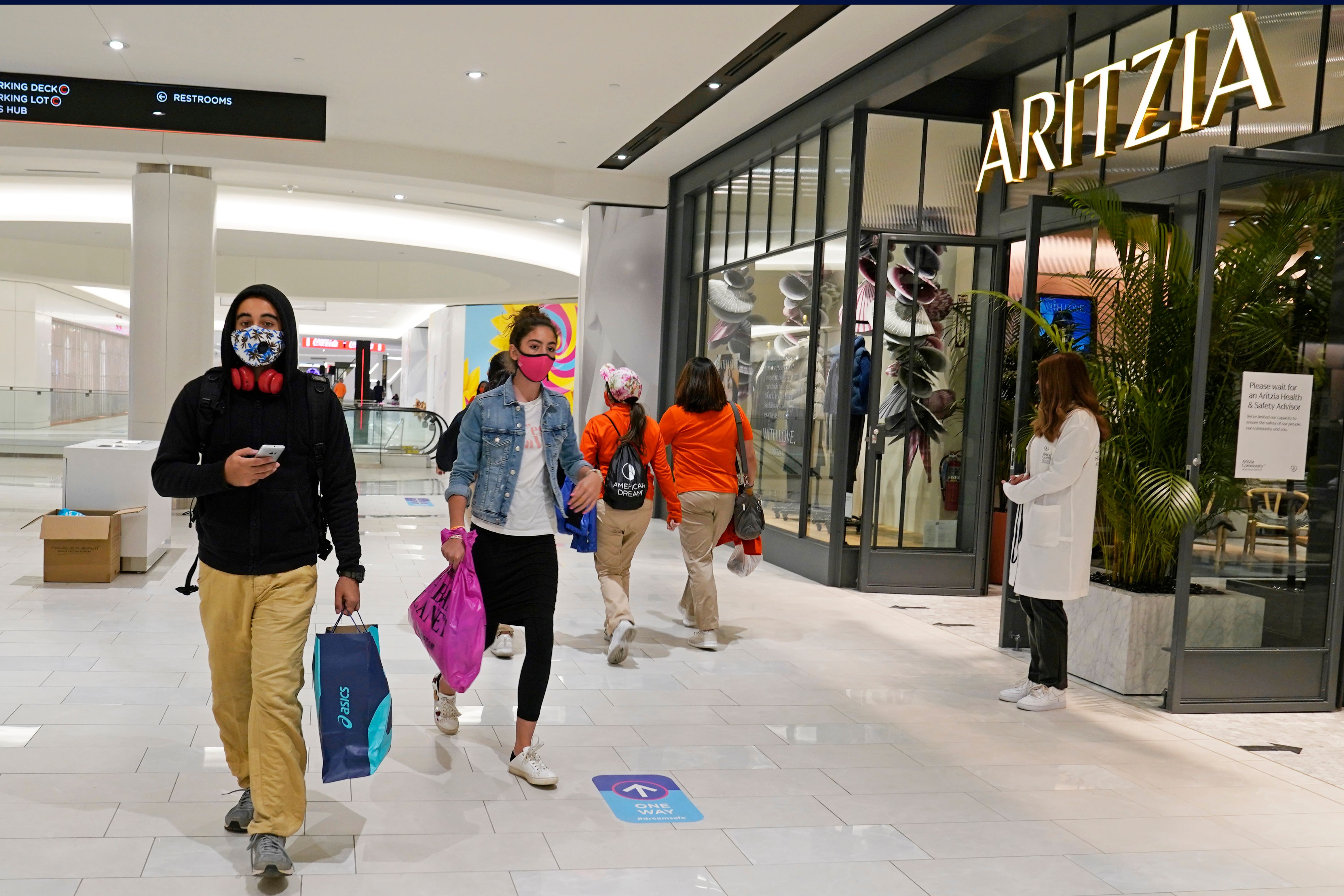 Shoppers wearing masks inside the mall