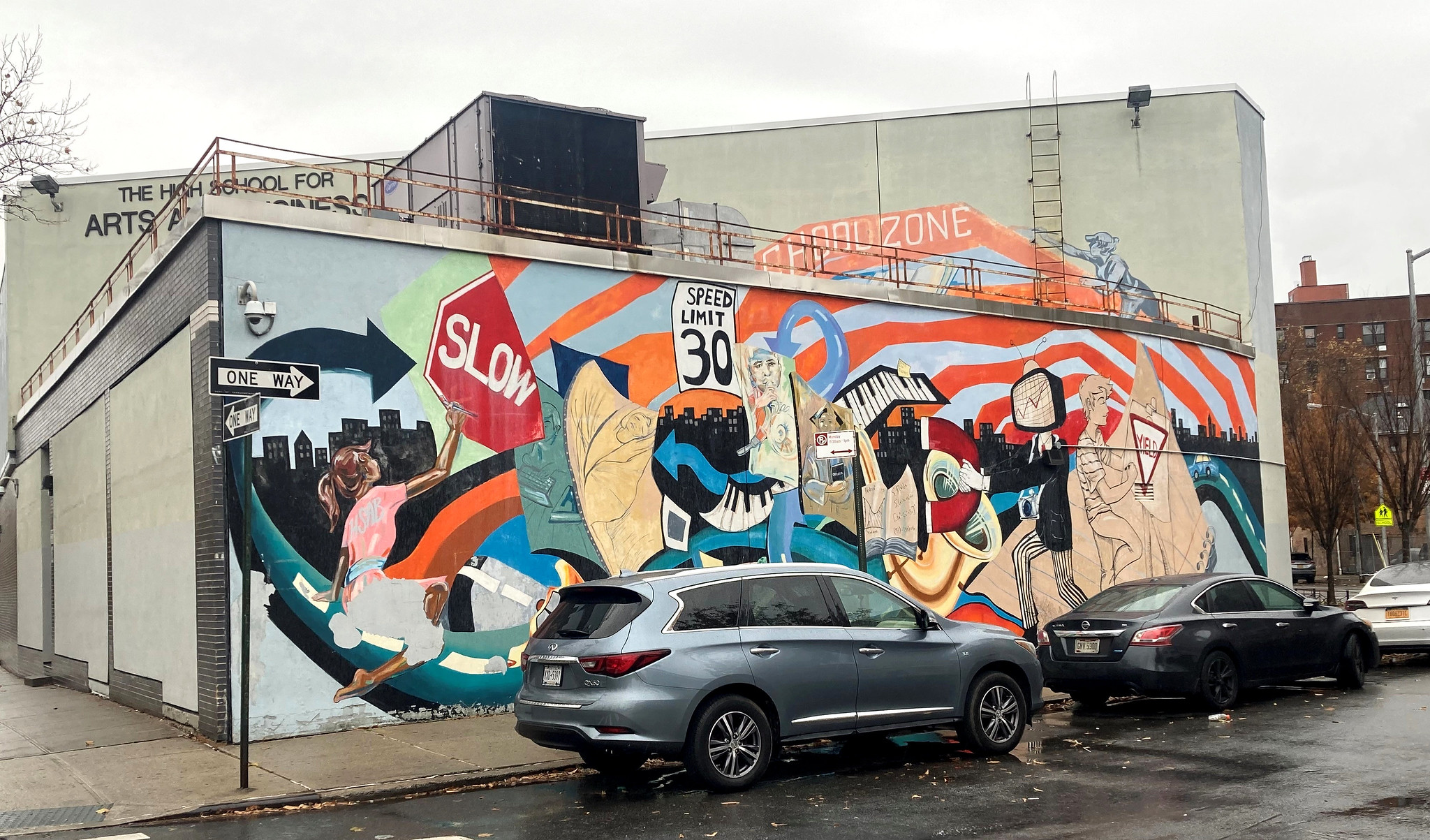 mural at an intersection telling drivers to slow down
