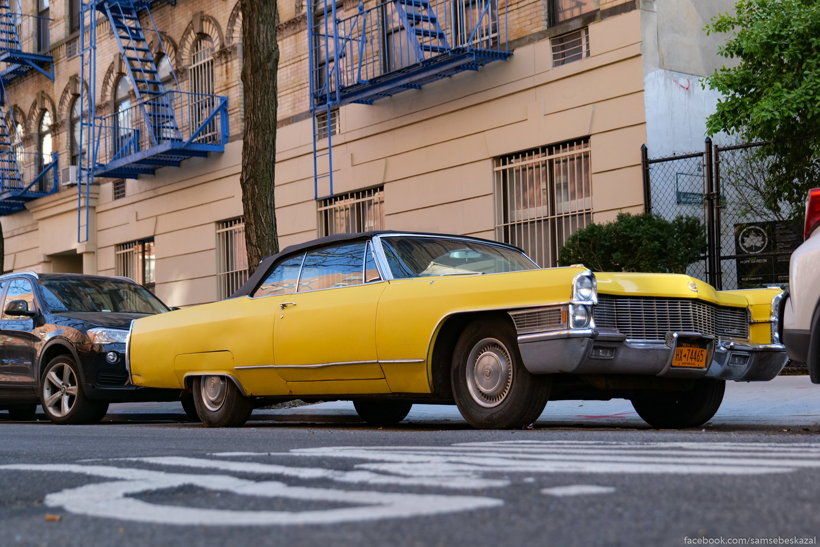 a yellow car parked on a city street